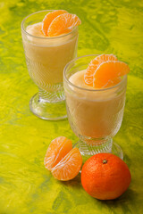Two vanilla pudding in glass with tangerine