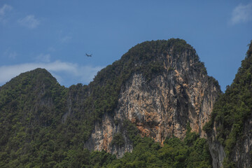 A large plane is flying over the mountains.