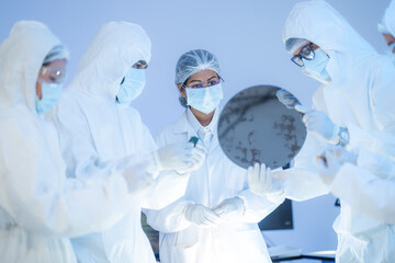 Semiconductor specialists analyzing silicon wafer for high-performance AI processor fabrication and nanotech supply chain solutions.