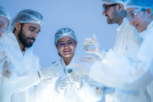 Semiconductor specialists analyzing silicon wafer for high-performance AI processor fabrication and nanotech supply chain solutions.