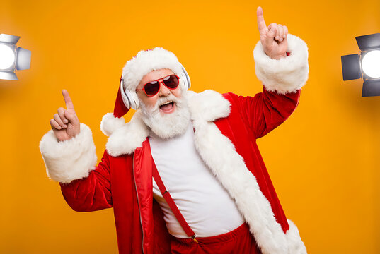 Nightclub invite on christmas party celebration funky crazy santa claus dj in white headset sing song sound melody listen music dance wear stylish x-mas hat suspenders isolated yellow color background