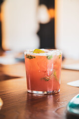 Tequila cocktail with fruit and mint served at an upscale food restaurant