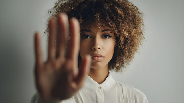 Young woman showing stop gesture protesting refusal
