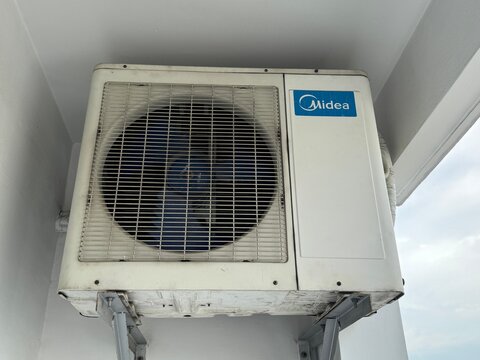 Midea Outdoor Air Conditioner Unit (HVAC Equipment) on a Building in Ho Chi Minh City, Vietnam, October 2025. 