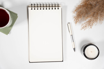High-angle vertical shot of a blank open notebook with aesthetic boho decor. Ideal for Instagram stories, Pinterest pins, or social media content backgrounds.