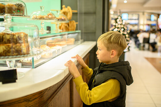 Boy walking through a modern shopping mall, exploring stores and enjoying a casual indoor outing, capturing a candid moment of childhood in an urban environment.
- Powered by Adobe