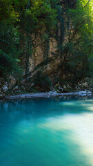 blue lake and cliffs high in the mountains