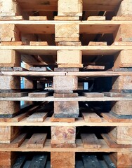 Wooden pallets stacked in a warehouse, closeup of photo