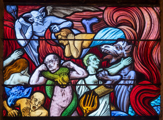 Stained glass (19th century) of Vision of hell and demons tormenting souls.