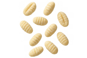 Uncooked potato gnocchi falling, traditional italian pasta dumplings, delicious carbohydrate food on transparent background