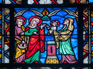 Stained glass (19th century) of Childhood of Jesus: Presentation of Jesus in the temple by Mary and Joseph.