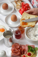 Young woman enjoying hotel breakfast with various choice of food	