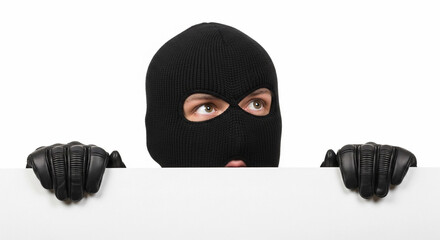 A masked burglar peeks over a white empty banner. The individual wears a black ski mask and leather gloves, suggesting stealth and secrecy in a robbery context.