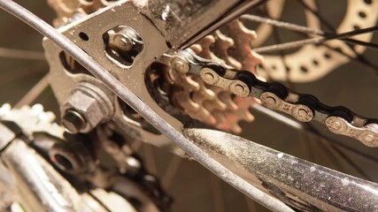 Bicycle chain and gear spinning. Moving mechanical components.