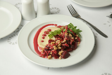 Beetroot salad served with hummus and fresh arugula	