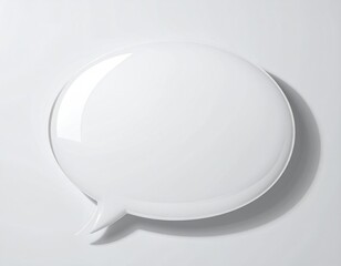 Glossy white speech bubble on light surface, angled view