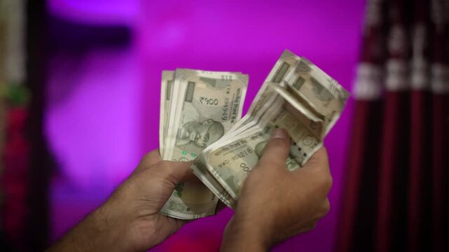 Indian 500 Rupee Notes in Hand &ndash; Currency Closeup