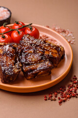Grilled or bbq pork ribs with sauce, a food prepared for dinner. Grilled ribs