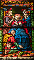 Fototapeta premium Stained glass (16th century) of Death of Saint Joseph surrounded by Mary and Jesus.