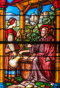 Stained (19th century) glass of Jesus and the Samaritan woman at the well.