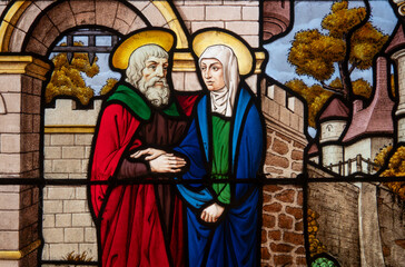 Naklejka premium Stained glass (19th century) of Anne and Joachim meet at Jerusalem's golden gate.