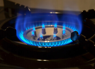burning gas stove. flame of a gas stove on a dark background close-up. gas crisis and rising energy prices