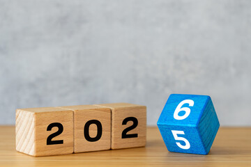 2026. Wooden blocks with a date changing the year from 25 to 26. Business concept. Symbol of upcoming events and changes. Copy space