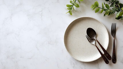 Minimalist dining setting with speckled plate and dark cutlery image
