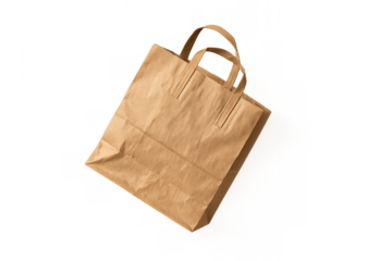 Brown kraft paper bag with handles floating, empty reusable shopping bag for takeaway marketing and eco friendly concepts
