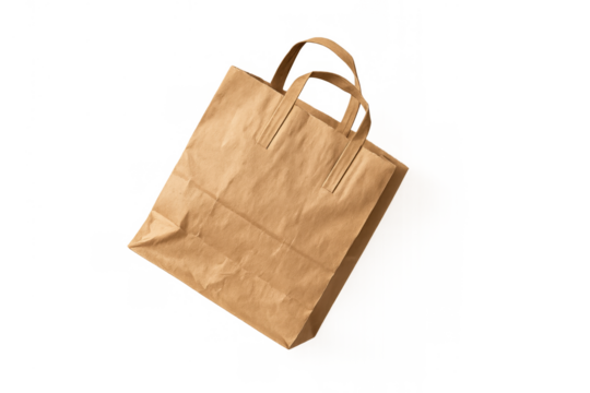 Brown kraft paper bag with handles floating, empty reusable shopping bag for takeaway marketing and eco friendly concepts
