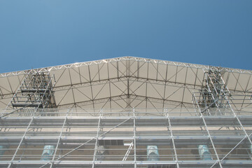 Scaffolding on the roof of a construction site to protect workers from the sun's rays and heat, Rome, Italy.
