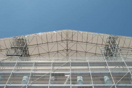 Scaffolding on the roof of a construction site to protect workers from the sun's rays and heat, Rome, Italy.