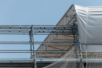 Scaffolding on the roof of a construction site to protect workers from the sun's rays and heat, Rome, Italy.
