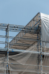 Scaffolding on the roof of a construction site to protect workers from the sun's rays and heat, Rome, Italy.