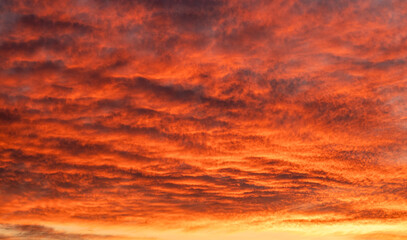 Fiery sunset sky over a dramatic orange horizon, perfect for nature and travel themes.