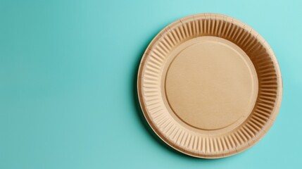 A round, brown, disposable paper plate on a turquoise background. The plate has a ribbed edge and a smooth center, suitable for serving food.