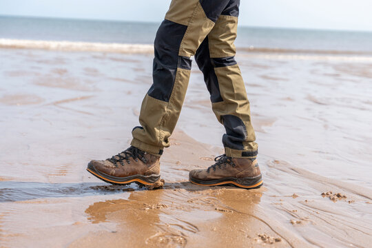 Walking on the beach in sturdy boots during a sunny day
