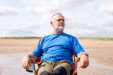 Relaxing man sitting on the beach during a sunny day