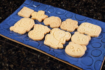Cookies, buttery biscuits shaped like little animals on a plate.