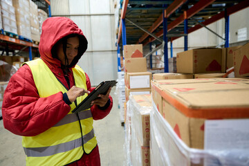 Woman managing cold chain inventory in warehouse