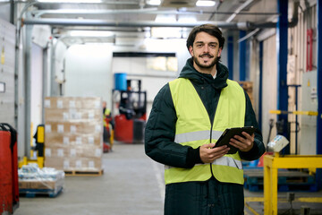 Worker managing cold chain logistics inventory using tablet
