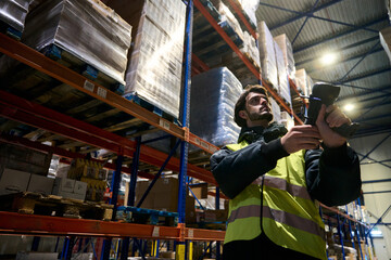 Warehouse worker scanning inventory in cold chain logistics