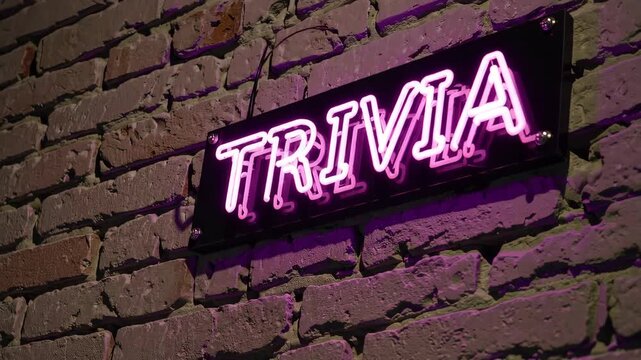 Pink neon trivia sign glowing on dark brick wall, game show event and knowledge contest background