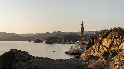 Coastal view of Sidab in Muscat with rocky hills and calm water in the early morning