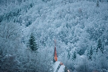 Chapel at the foot of the hills in a winter landscape