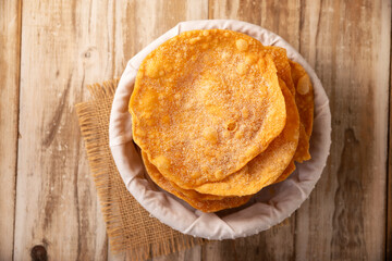 Buñuelos de rodilla. Traditional food at Christmas and winter holidays in Mexico, these are fried dough flour sprinkled with sugar or covered in a syrup made with piloncillo, cinnamon, and guava.