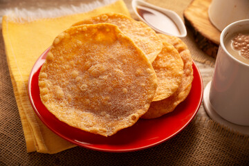 Buñuelos de rodilla. Traditional food at Christmas and winter holidays in Mexico, these are fried dough flour sprinkled with sugar or covered in a syrup made with piloncillo, cinnamon, and guava.
