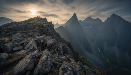 Dramatic mountain ridge at sunset with deep valley and distant peaks suggesting remote hiking adventure arctic tourism and resilient nature power