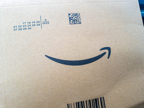 Rzeszow, Poland - November 22, 2025: A close-up of an Amazon packaging box, featuring the iconic smile logo, reflecting online shopping and e-commerce convenience.