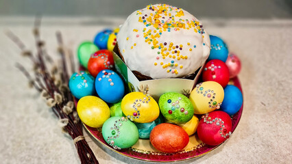 Fototapeta premium A plate of Easter eggs with a cake on top